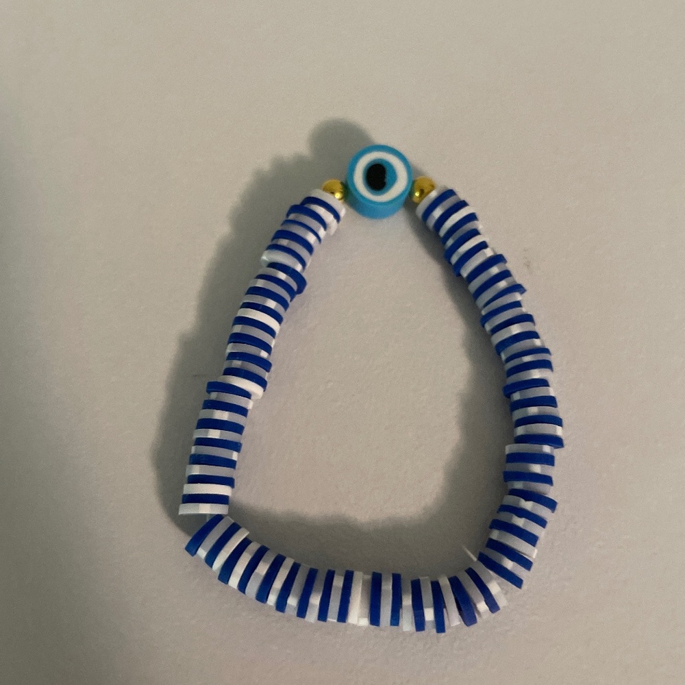 White and navy blue bracelet with an evil eye charm